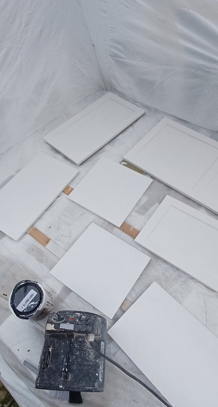 A room fully sheeted and masked before anything is opened.