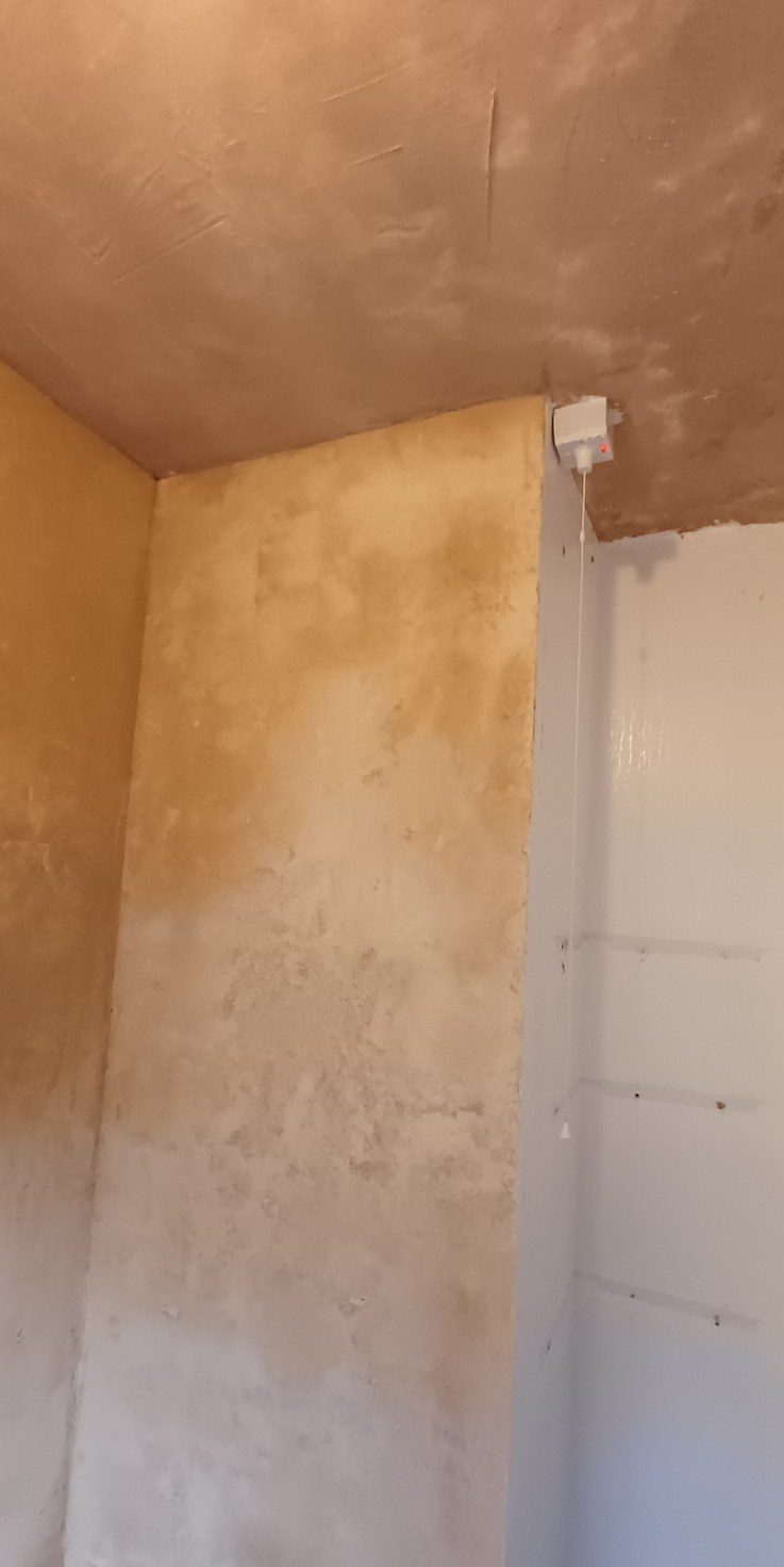 A kitchen wall and ceiling taken back to brick and fully replastered before any unit goes back.