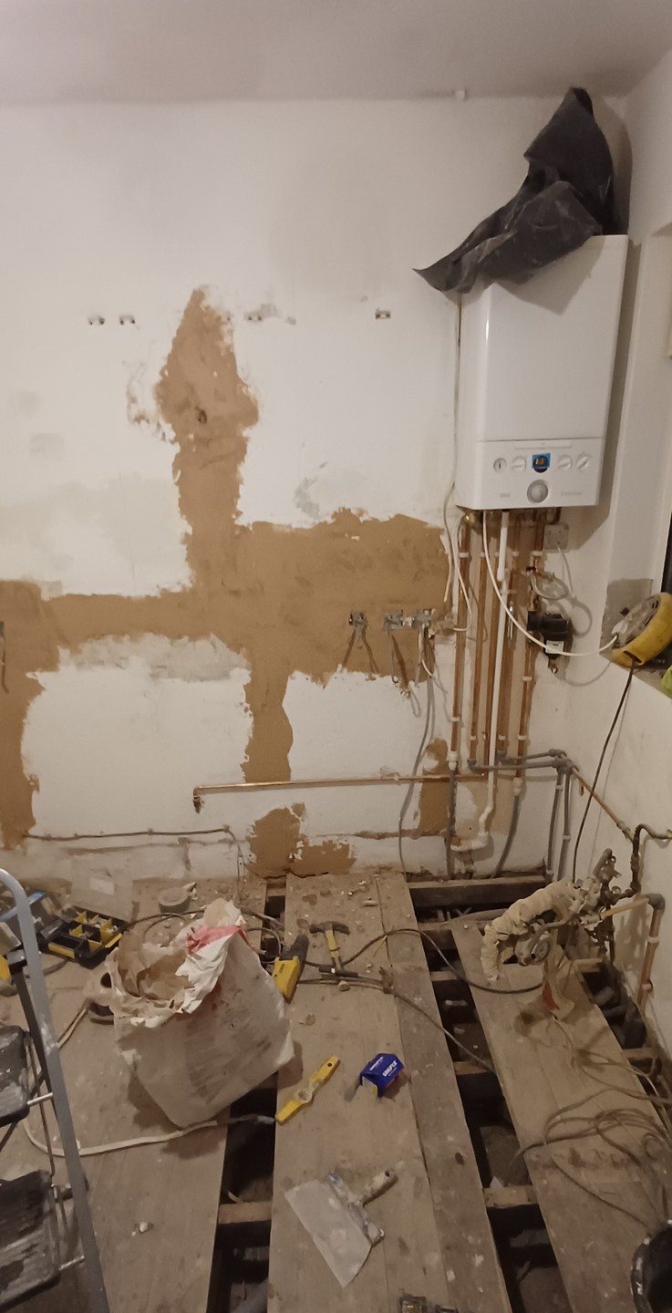 Making good around new pipework, so the patch reads as one surface instead of a scar.