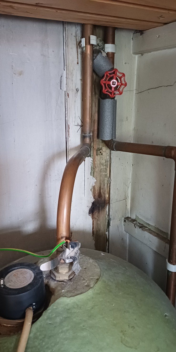 A hot water cylinder with its expansion vessel, pressure gauge and gate valve.