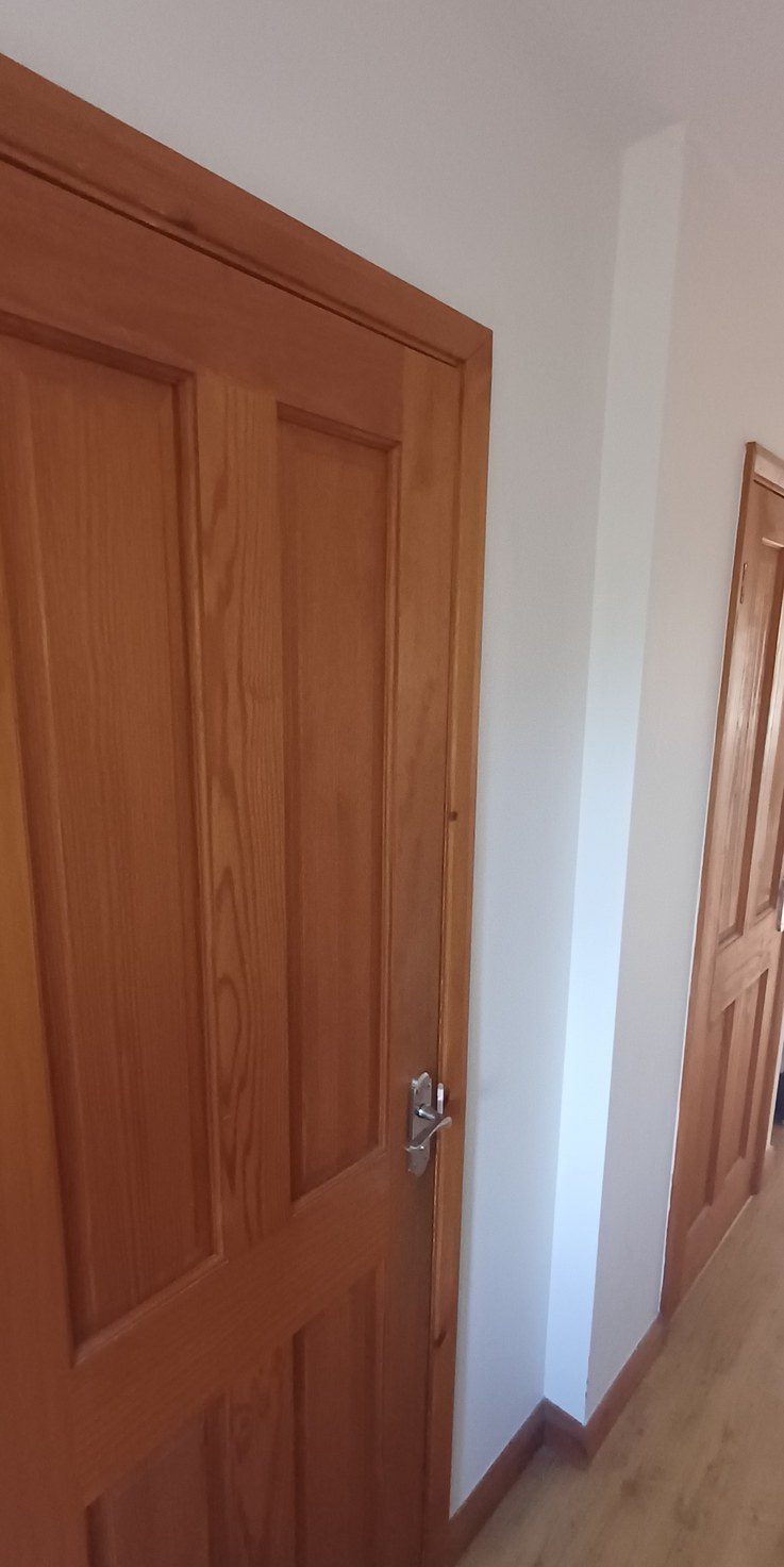 Internal doors hung and eased so they close on the latch.